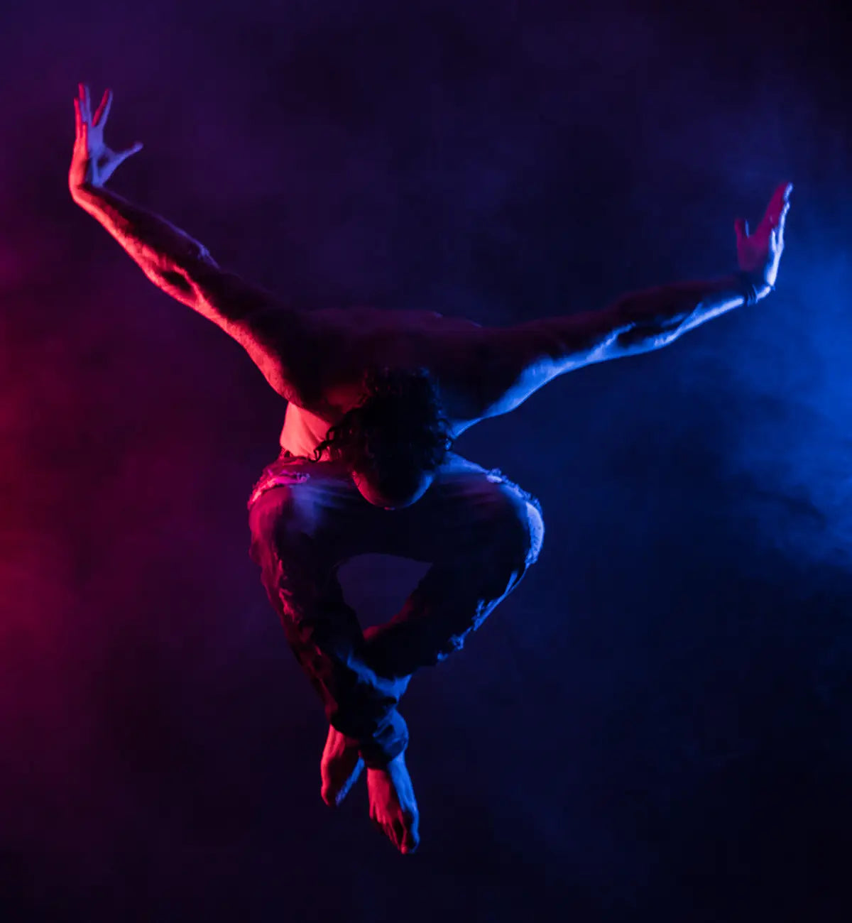 Male dancer posing in smoke with 2 AEOS 2 PROS lighting him