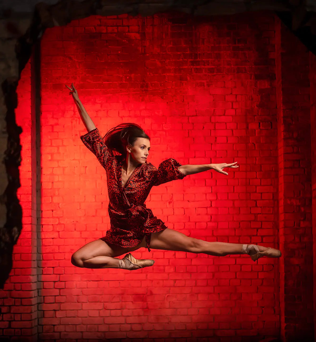 Dancer posing with ed background lit by NEO 3 PRO
